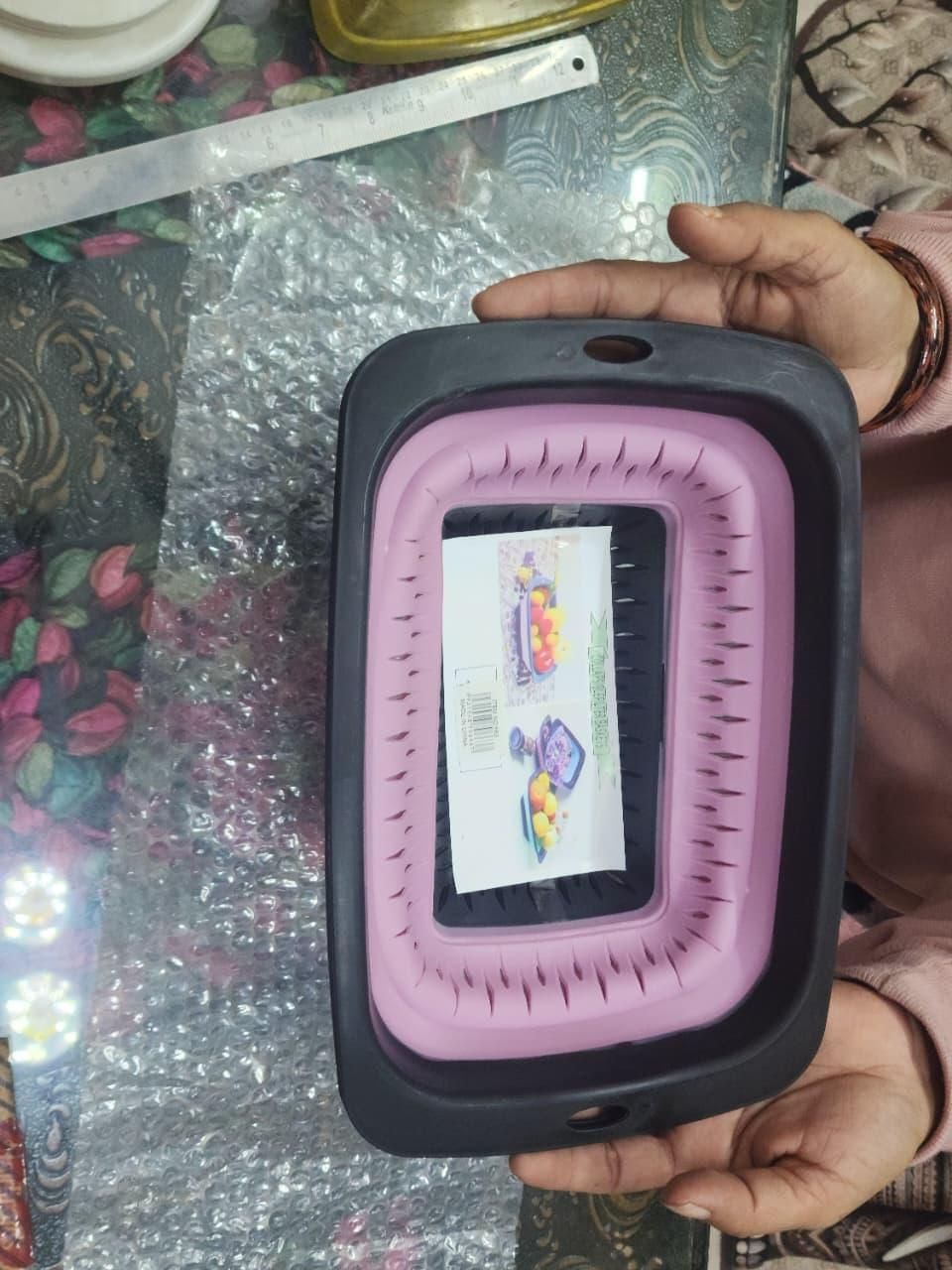 Foldable silicone washing basket used as fruit and vegetable drainer in kitchen